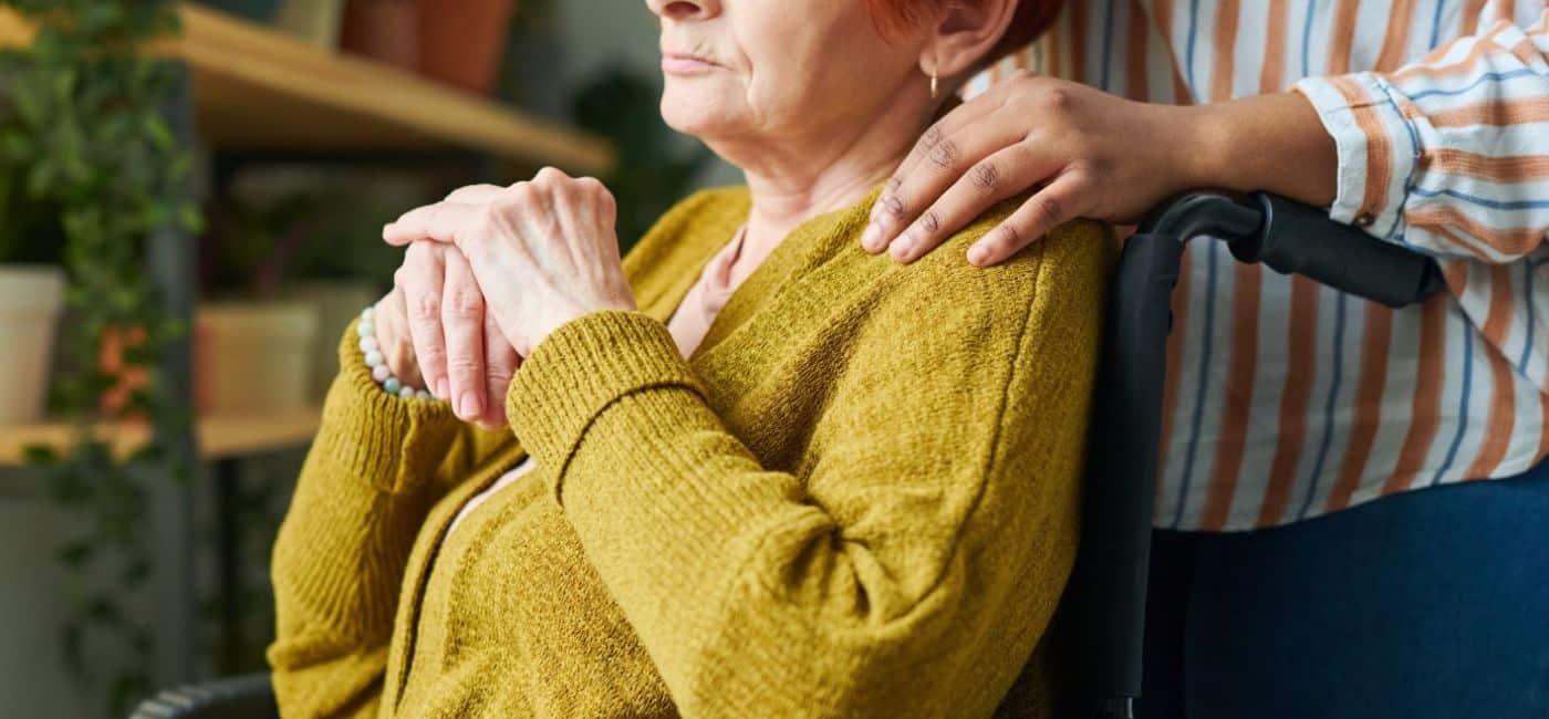 elder sitting in wheelchair with serious expression