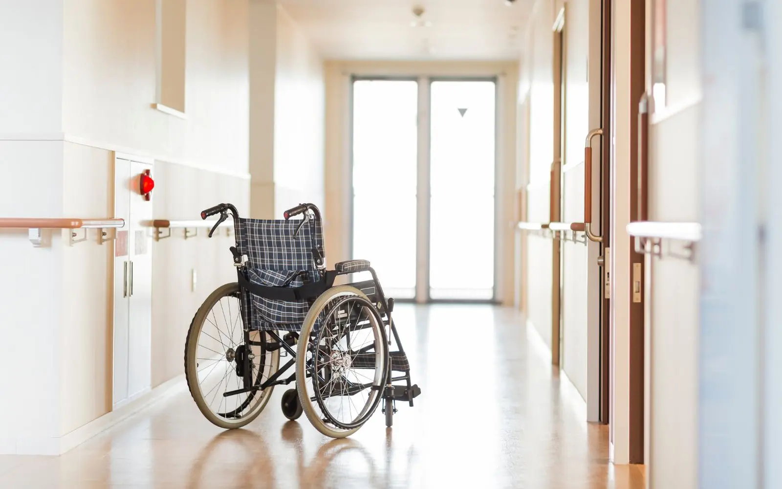 wheelchair sitting in hallway of nursing home