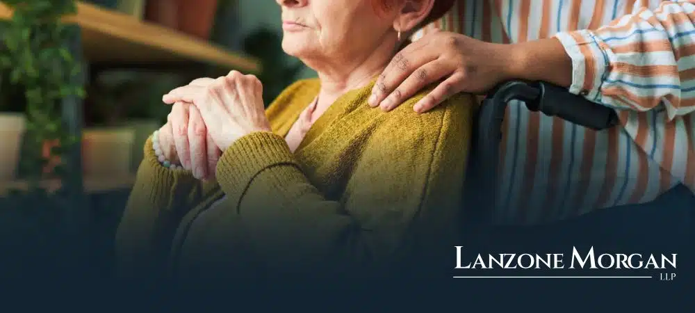 upset elder sitting in wheelchair in nursing home