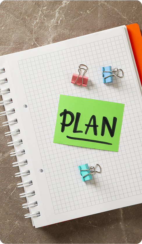 Notebook with clips and text Plan on gray background