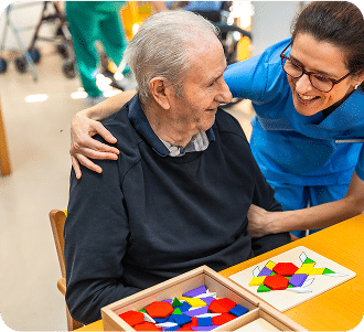 Senior man having fun with nurse playing board skill games
