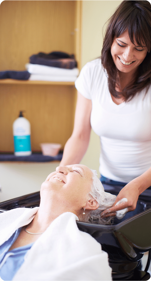 Senior woman at the hairdresser's getting her hair washed