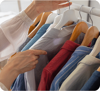 caucasian woman in her closet choosing clothes for work or outing, clothes