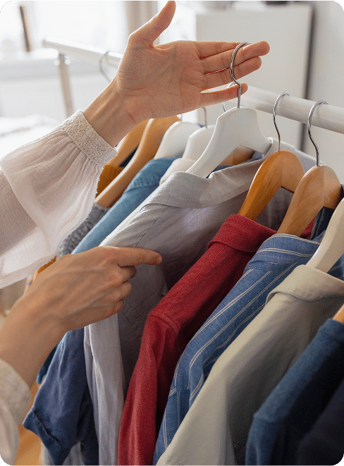 caucasian woman in her closet choosing clothes for work or outing, clothes