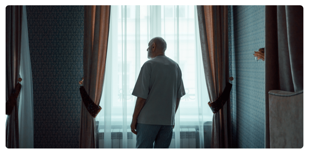elder looking outside window