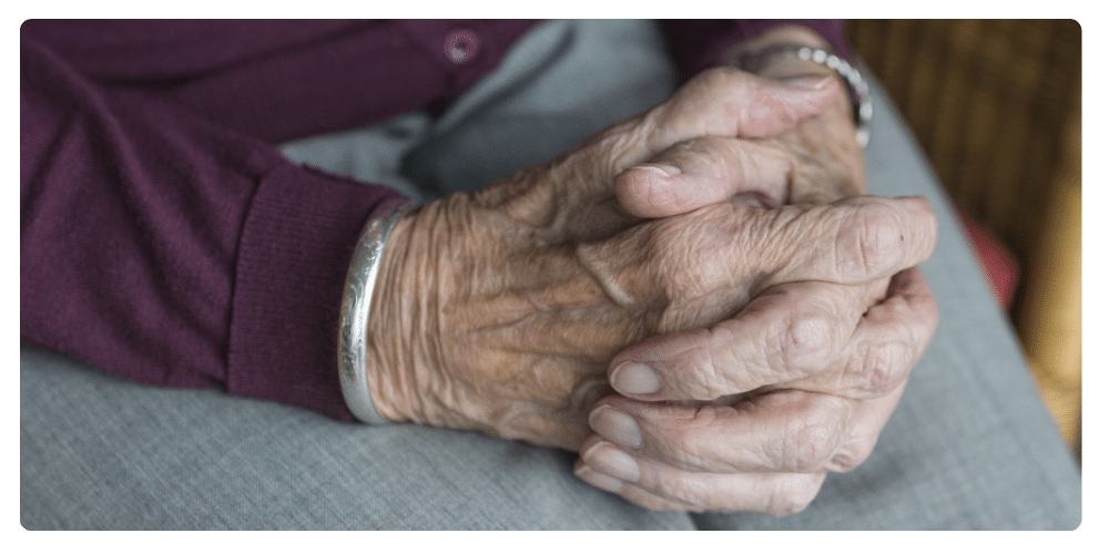 hands of senior citizen folded together