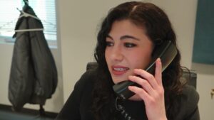 Woman answering a client with a telephone