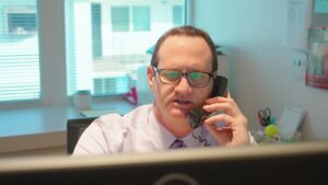 Attorney James Morgan on the telephone talking to a client about a nursing home abuse case in Los Angeles