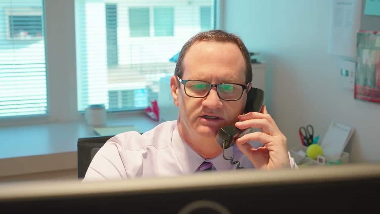 Attorney James Morgan on the telephone talking to a client about a nursing home abuse case in Los Angeles