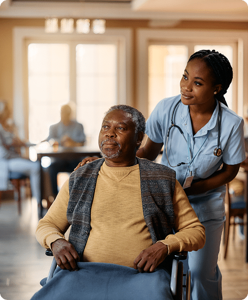 Staff member assisting nursing home resident